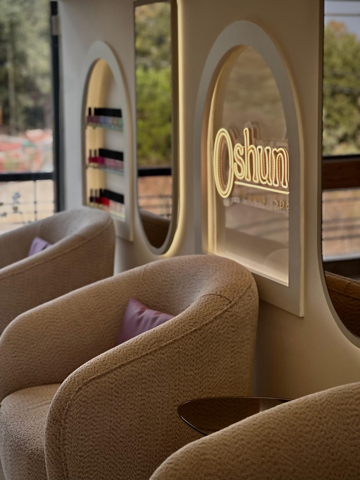 The illuminated gold Oshun sign above the pedicure lounge in Ballouneh
